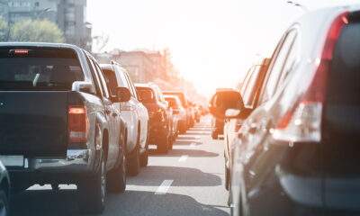 Evening traffic jam on busy city highway. Rows of car stuck on road due to crush accident. Sunset metropolis rush hour scene.