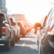 Evening traffic jam on busy city highway. Rows of car stuck on road due to crush accident. Sunset metropolis rush hour scene.