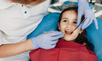Close up of a cute little kid getting teeth checked by a pediatric dentist