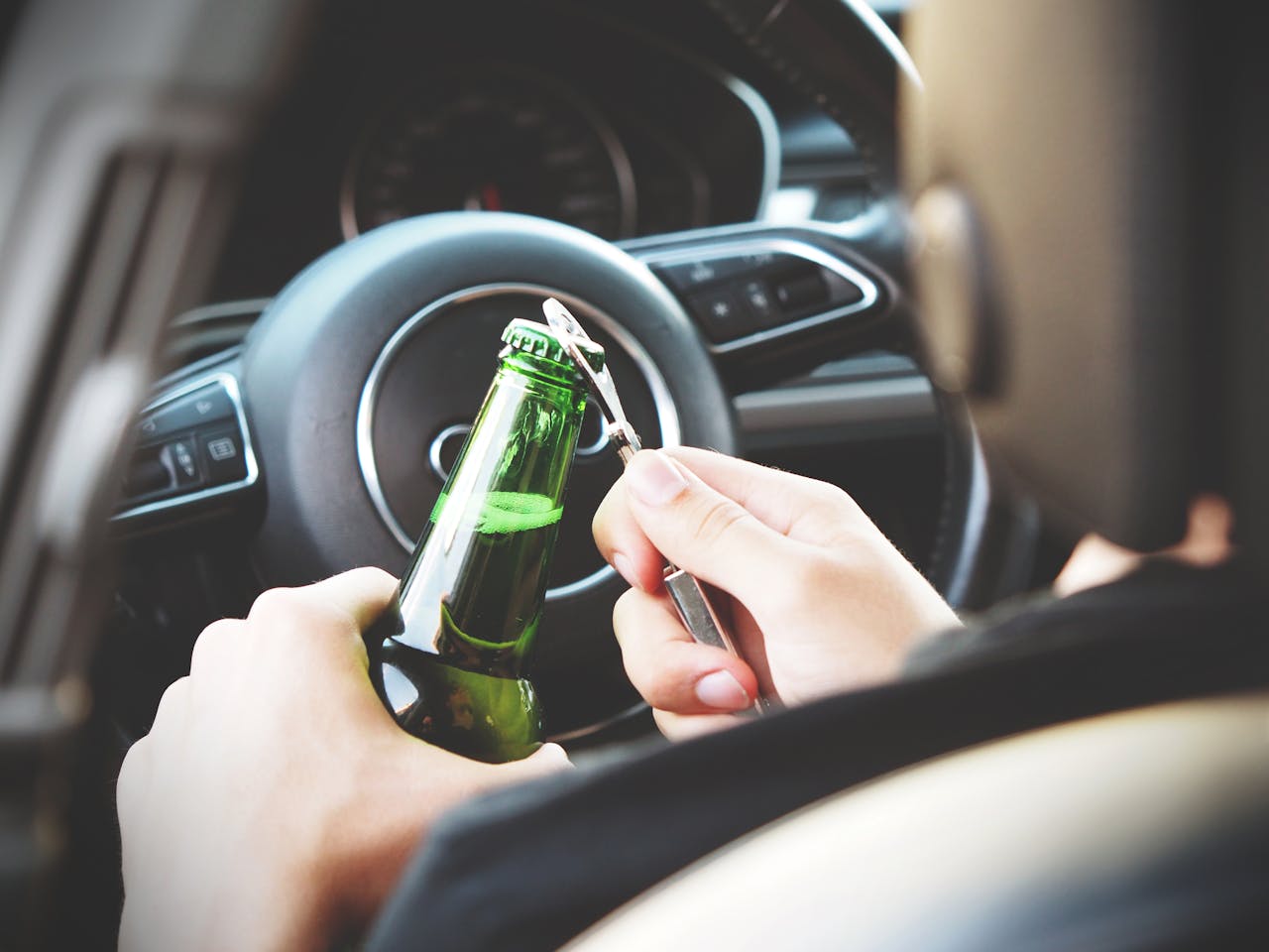 Photo by energepic.com: https://www.pexels.com/photo/person-opening-bottle-on-car-288476/