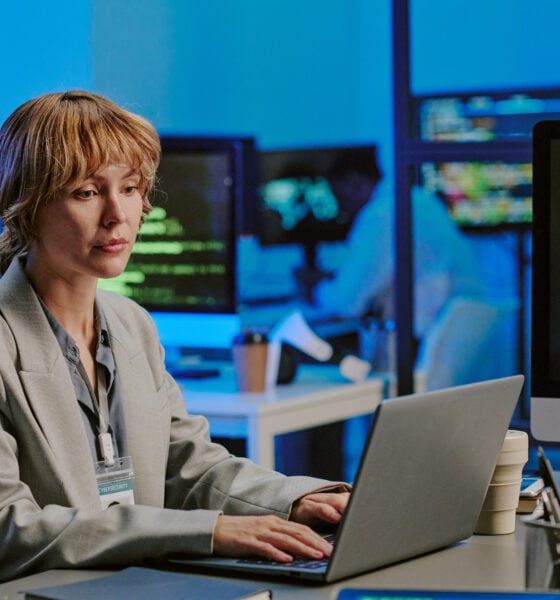 Young Woman Typing On Laptop In Cybersecurity Office